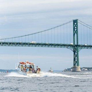 Campers boating under Mount Hope Bridge